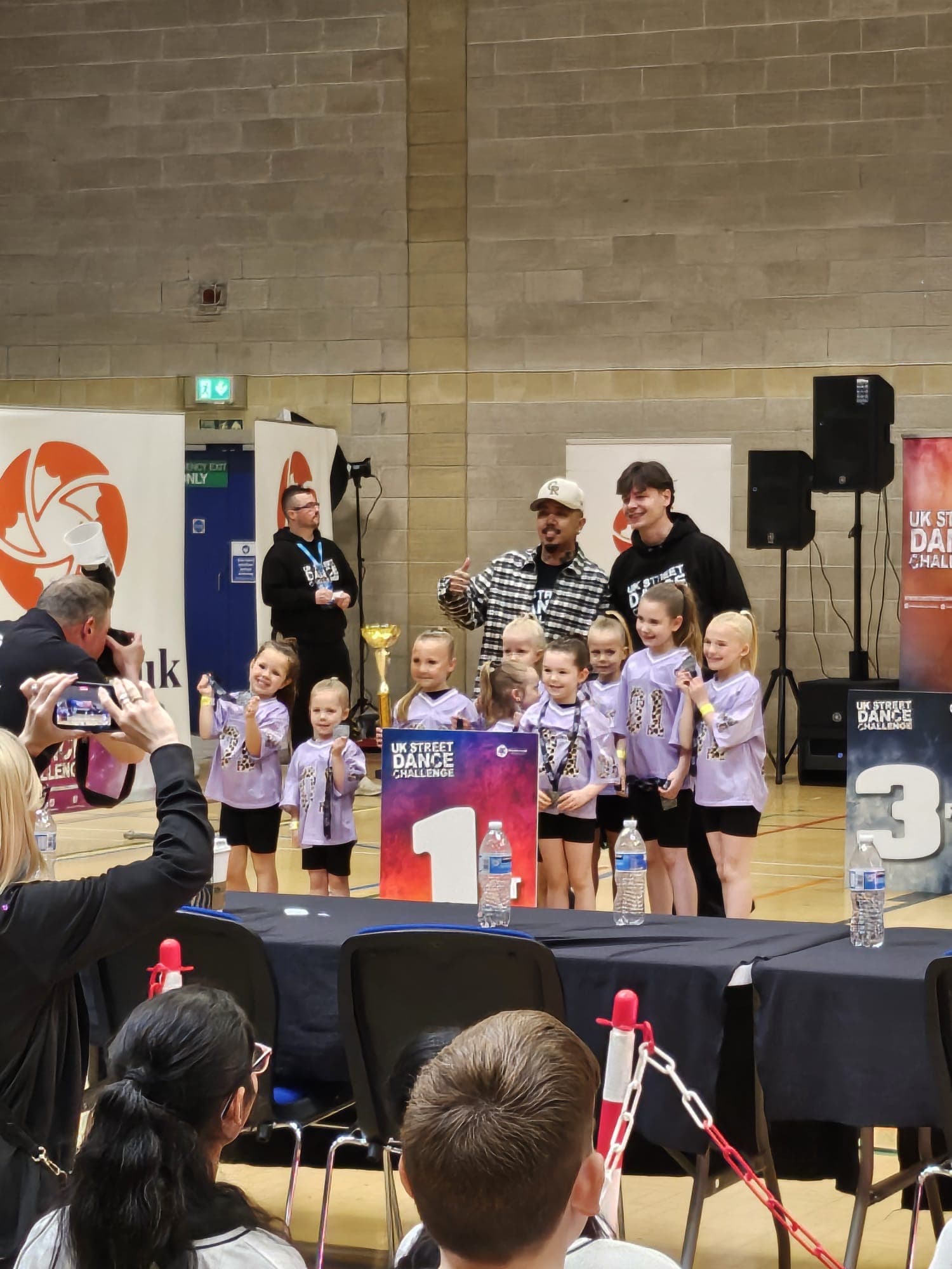 D2E Mini Juniors in purple leopard-print costumes receiving 1st place at the UK Street Dance Challenge
